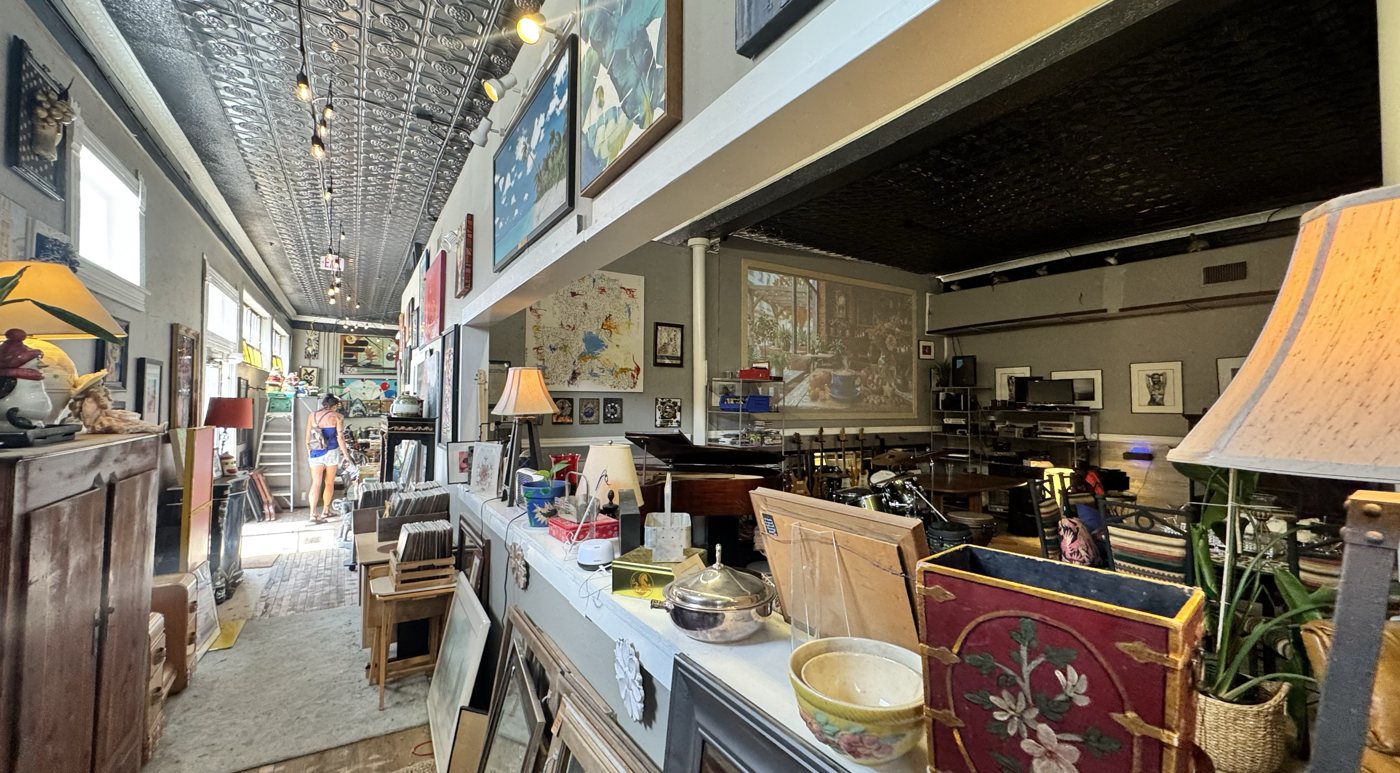 Inside the shop — tin ceilings, art walls, lamps, vinyl and vintage finds