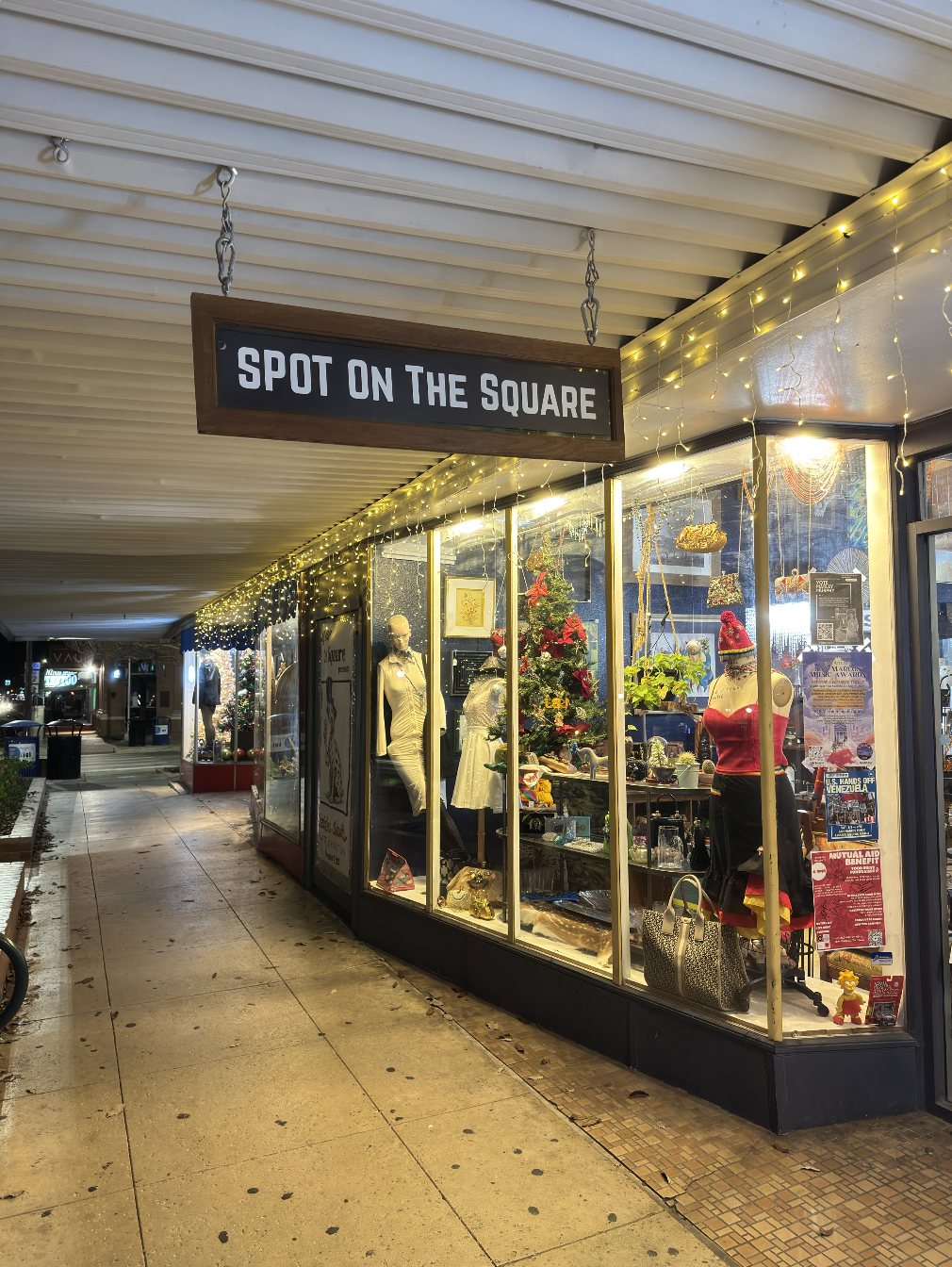Spot on the Square storefront at night — glowing windows on the downtown square